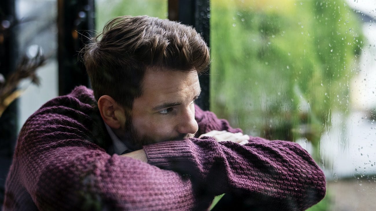 picture of a man looking out of a window