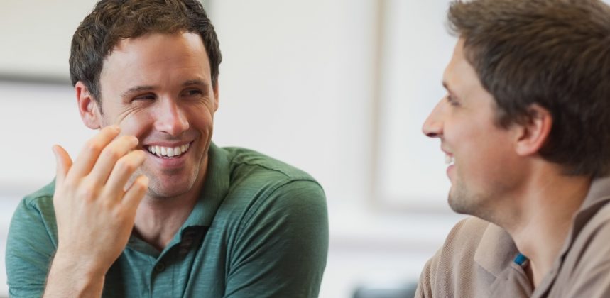 picture of two men talking and smiling